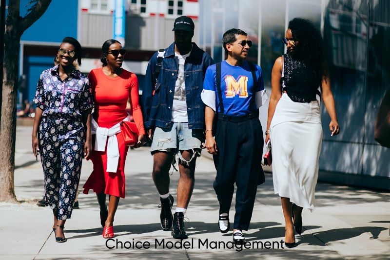 Diverse group of models of different ages, sizes, and ethnicities walking confidently in stylish outfits on a city street