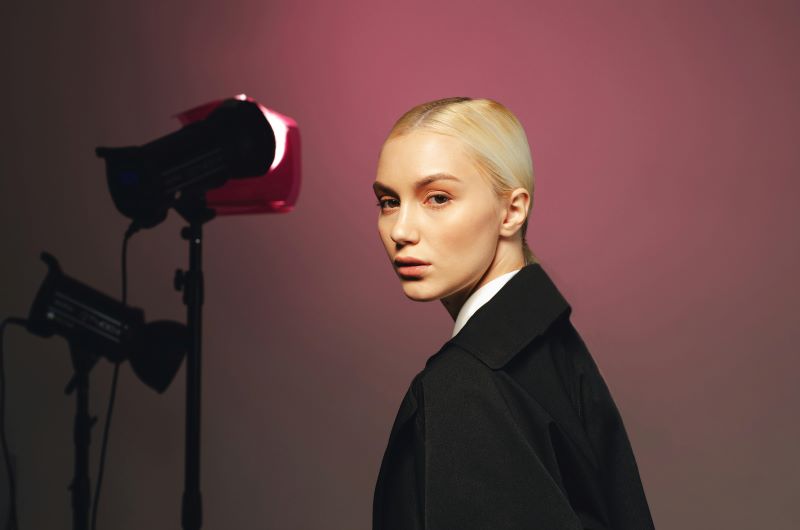 Aspiring UK model practicing essential modelling poses in a professional studio setting.