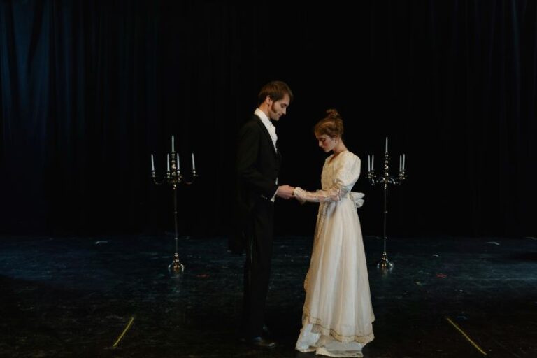 Aspiring actors in a UK acting workshop practicing stage performance and building confidence together.