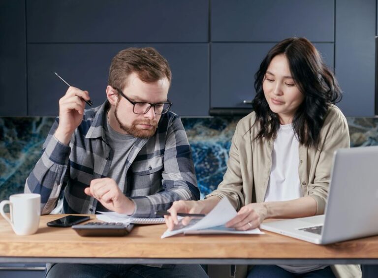 UK models and actors planning their budget together with notebooks and coffee cups