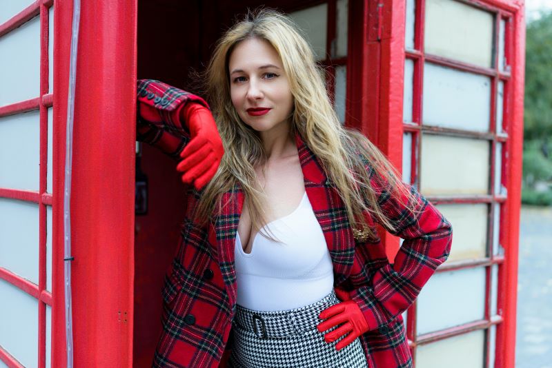 Confident UK model reviewing portfolio with her agency representative in a modern London studio.