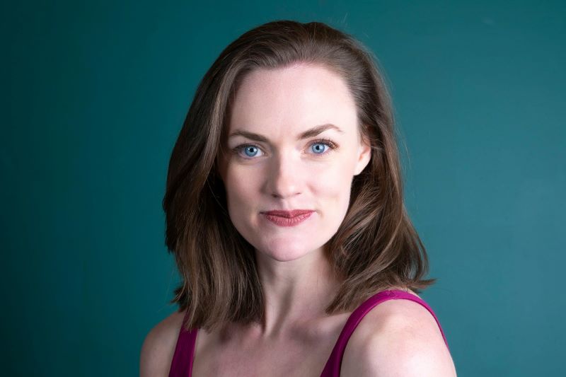 Young UK model posing in natural daylight for professional portfolio headshot, representing authentic beauty and confidence.