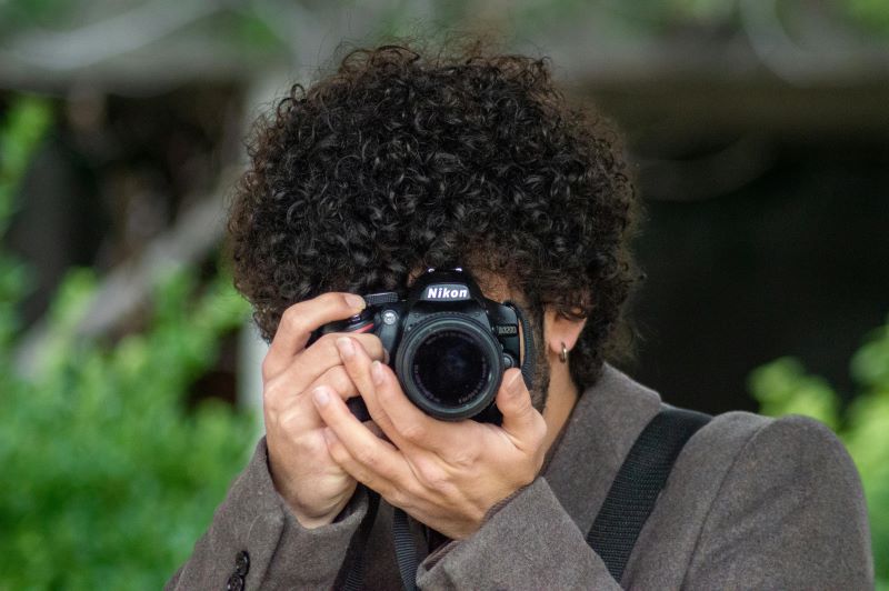 Aspiring model reviewing photos with a professional photographer during a UK portfolio shoot.