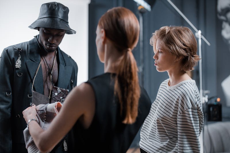 UK fashion model confidently communicating with a photographer on set