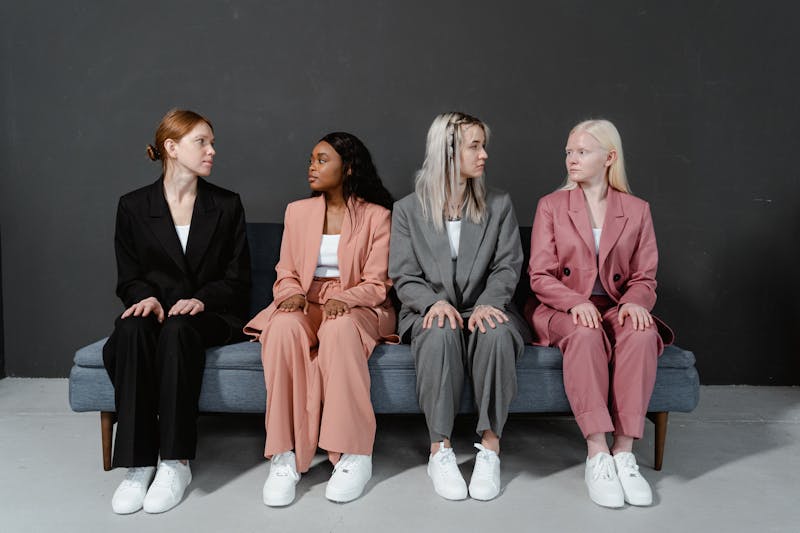 Aspiring fashion model attending a casting call in London while waiting among other models in a professional studio setting
